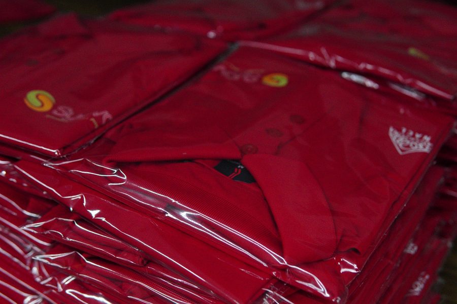 Folded red polos, ready to pack